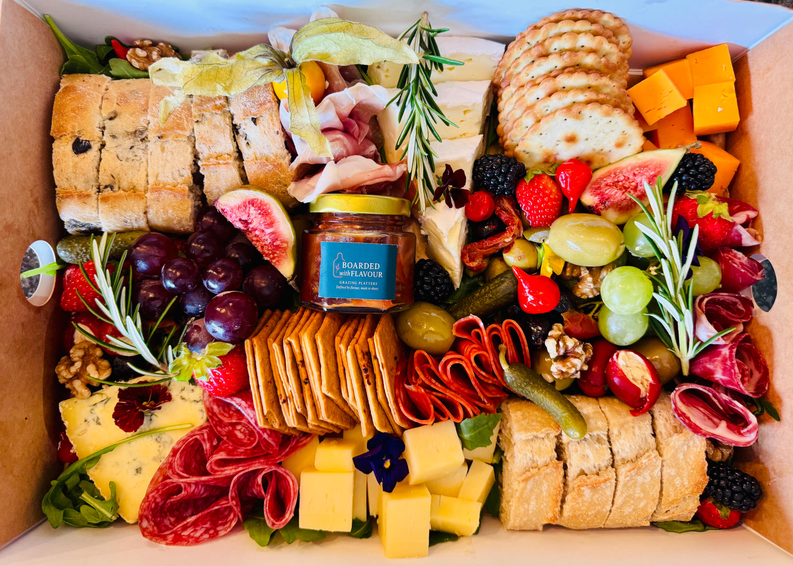 selection box of cheeses, meats, fruits and charcuterie