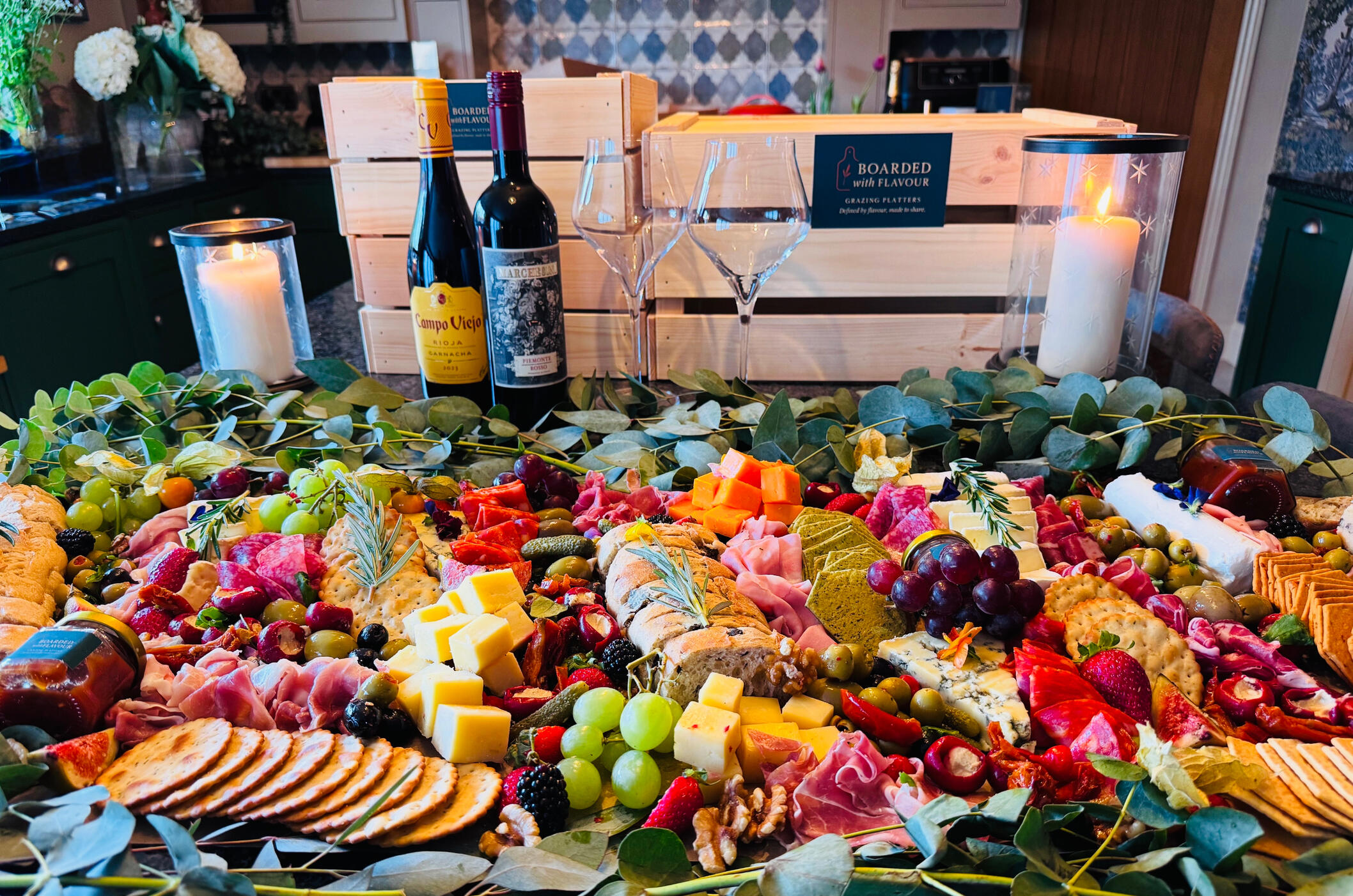 A small grazing table with a selection of charcuterie, mixed meats, fruits and cheeses